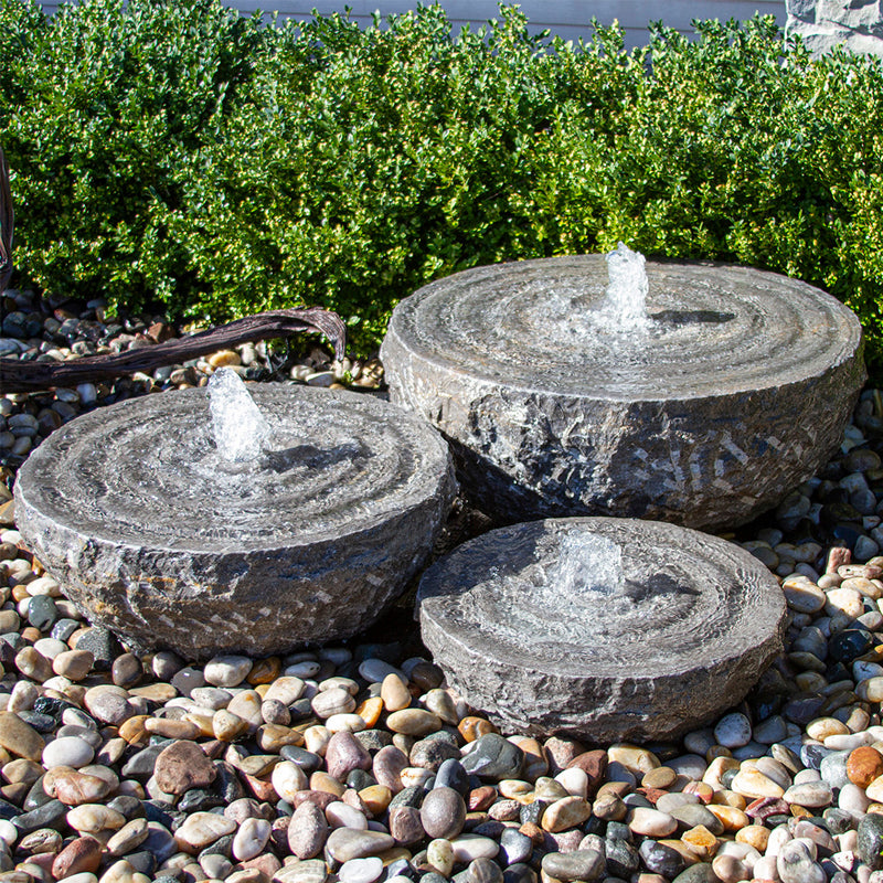Set of three natural stone bowls with swirl fountains