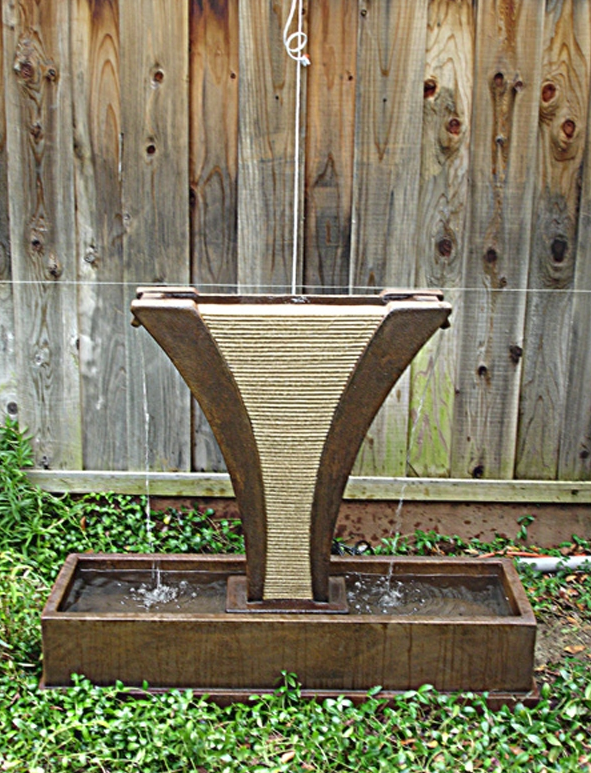Outdoor water feature with cascading side spills
