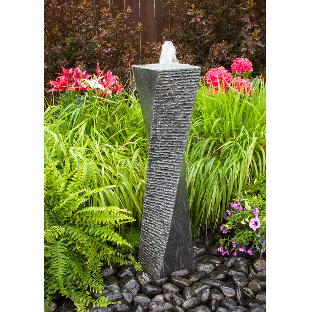 Image of a polished granite stone fountain with a twisted design