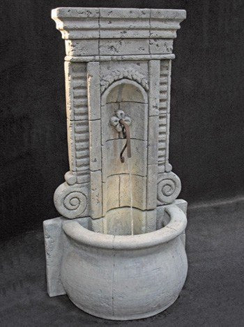 Tall outdoor fountain with a champagne wall design