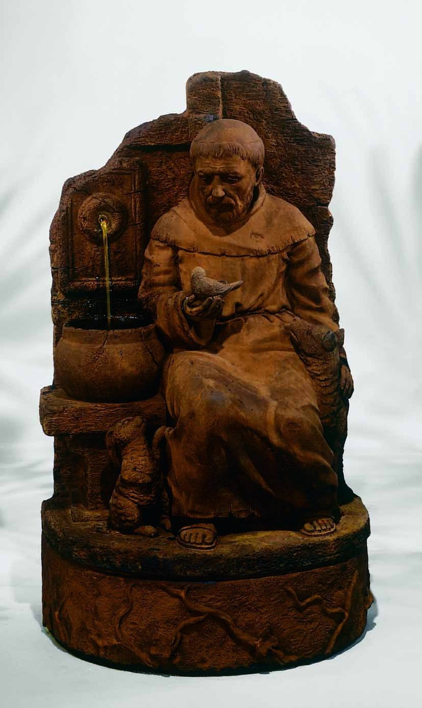 Outdoor garden fountain featuring a statue of St Francis at a well