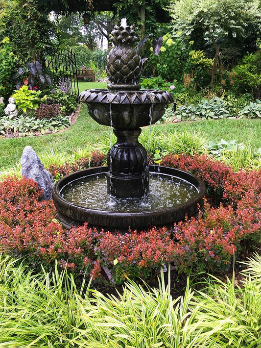 Outdoor fountain with pineapple design in round pool