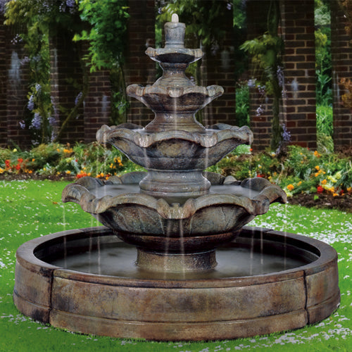 Image of a four tier outdoor water fountain in a garden setting