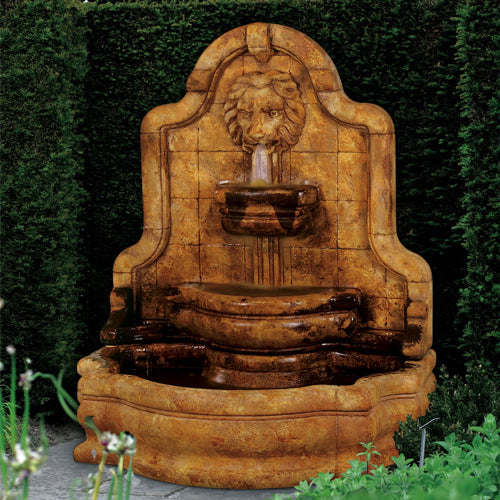 Outdoor water feature with lion head and narrow basin