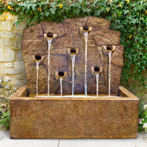Image of a rock wall garden fountain