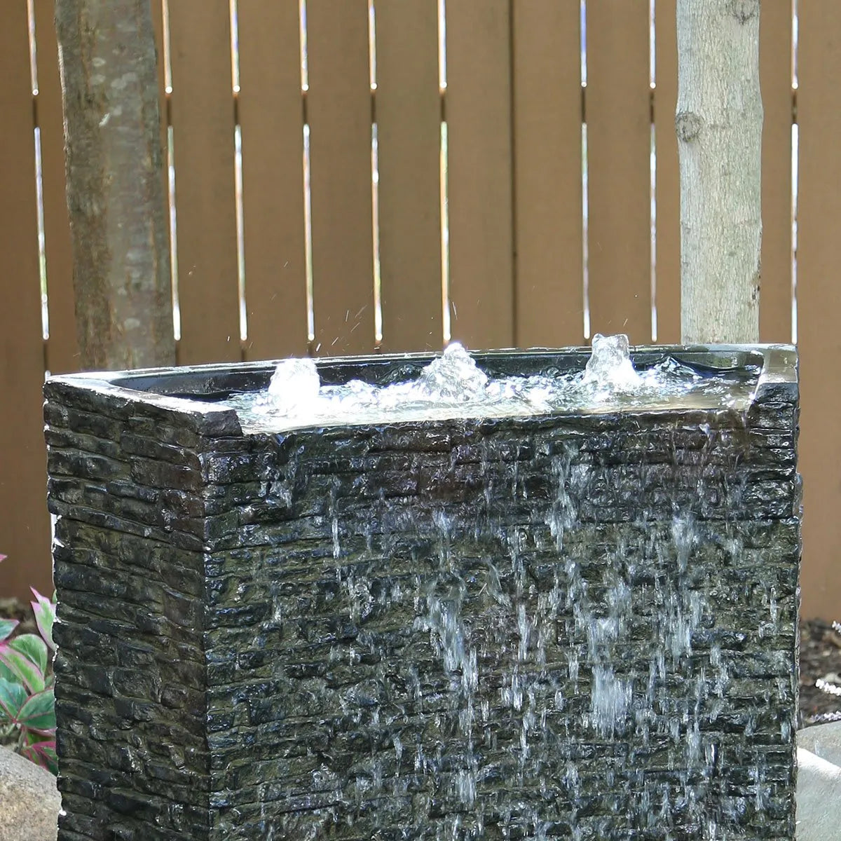 Stacked slate wall topper with curved front spill feature