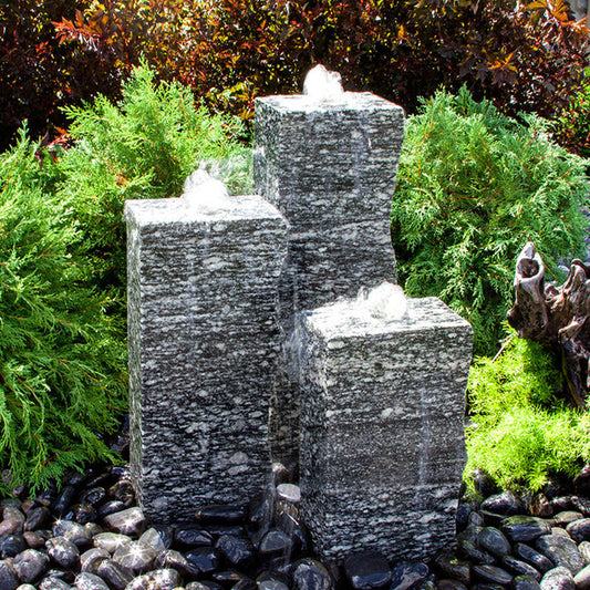 Image of a rough speckled granite triple stone fountain.