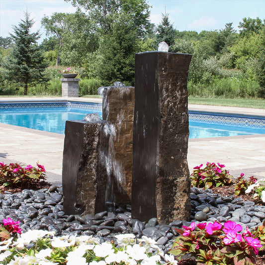 Image of a basalt stone fountain with one side polished
