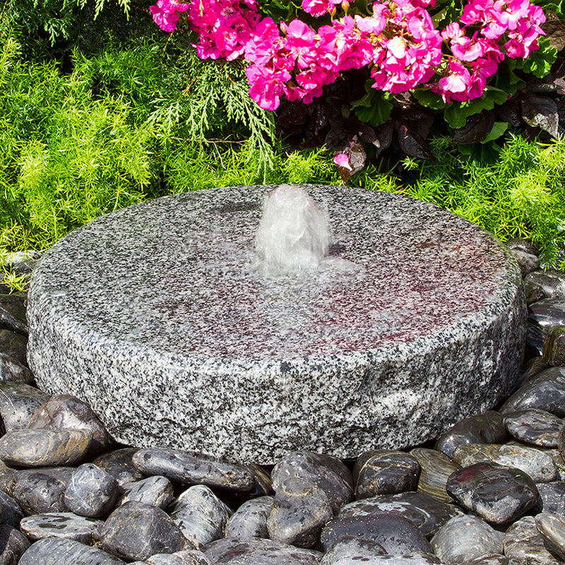 Image of a natural round granite stone fountain