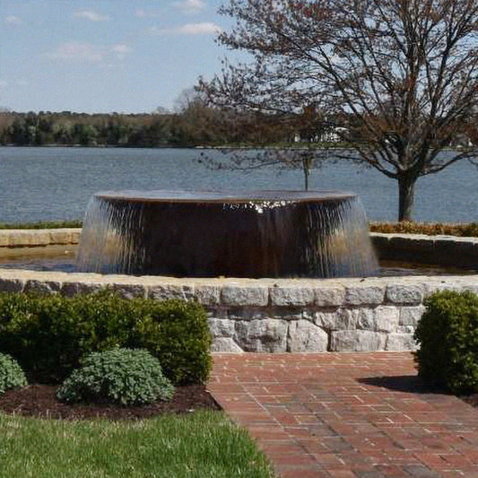 Image of a rustic cast iron fountain designed like a sugar kettle.