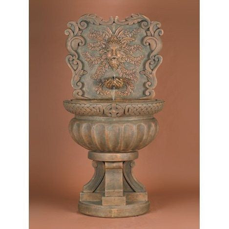Outdoor wall fountain featuring a green man design