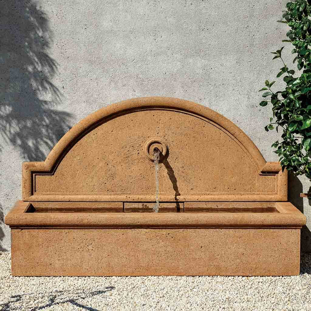 Curved back cast stone wall fountain for outdoor decor