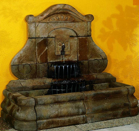 Outdoor wall fountain with fleur de lys design