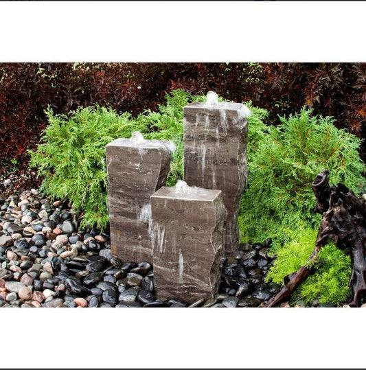 Image of a blue limestone triple rock fountain featuring three smooth sides.