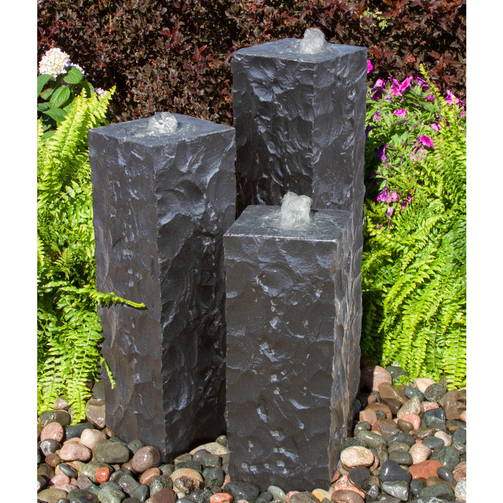 Image of a chiseled black basalt column outdoor fountain.