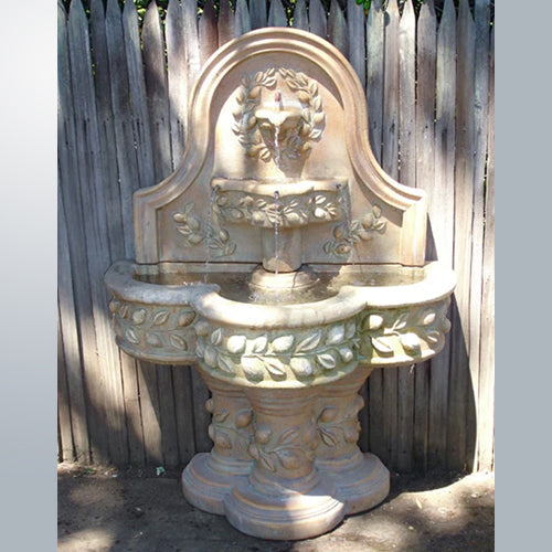 Image of a wall mounted outdoor water fountain with a lemon design.