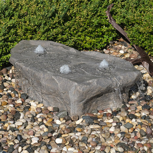 Outdoor stone fountain with cascading water feature