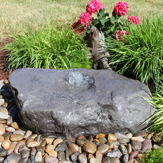 Image of a large bird bath fountain made from a boulder stone.
