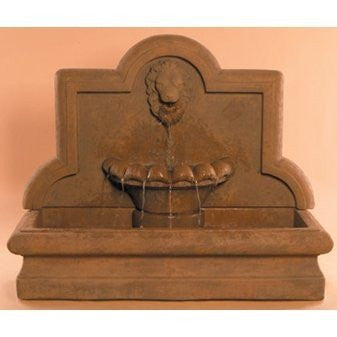 Large cast stone outdoor wall fountain featuring a lion design