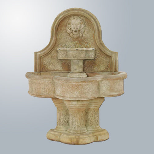 Outdoor water fountain with lion head design mounted on a wall