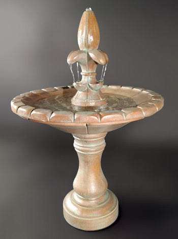 Image of a decorative outdoor water feature with a fleur de lis design.