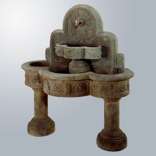 Image of a wall mounted outdoor fountain with a spout.