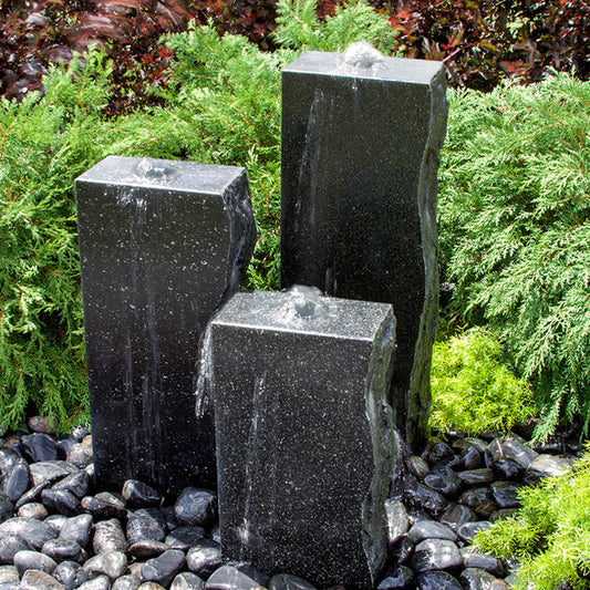 Rough black granite fountain with three smooth sides