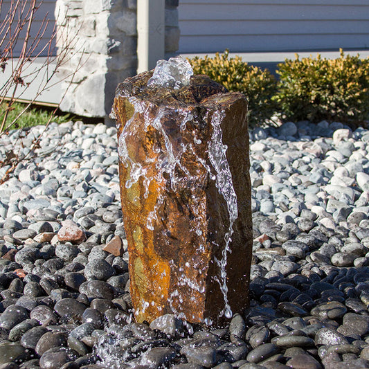 Image of a rustic basalt rock column fountain