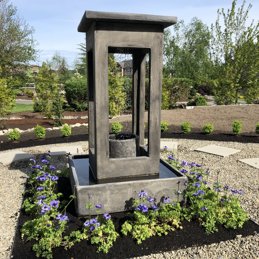 Outdoor fountain with smooth center column and square basin