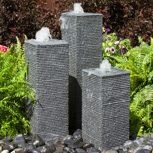 Outdoor fountain with square chiseled stone towers