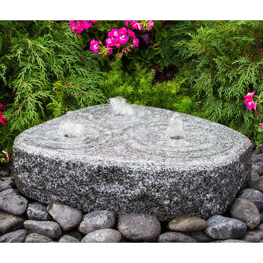 Image of a granite stone fountain with three circular tiers