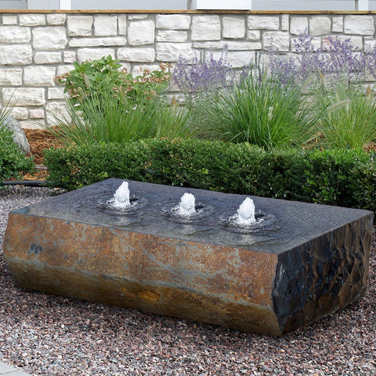 Stone fountain with three drilled holes