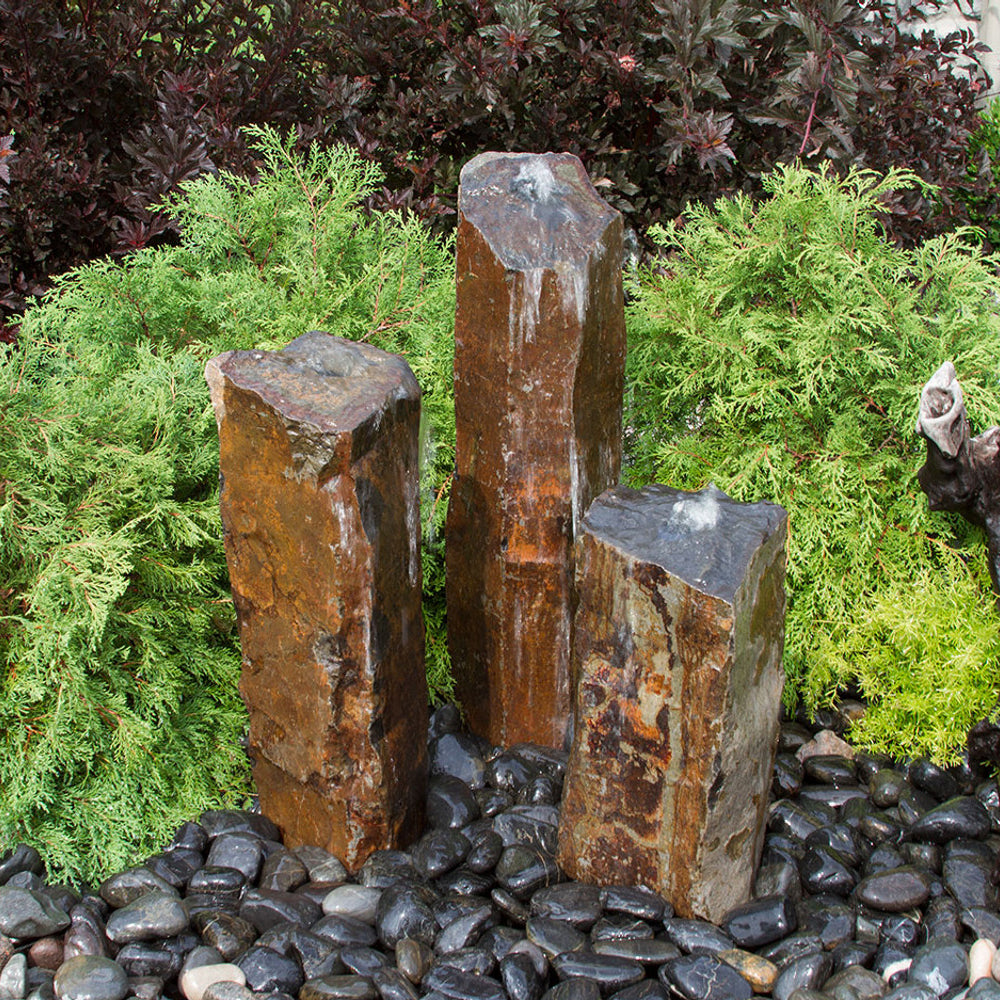 Image of a triple rustic basalt stone outdoor fountain
