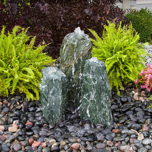 Image of a triple sea green chiseled stone fountain.