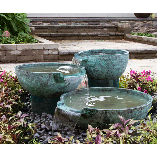 Outdoor water feature with three spillways and a stone bowl design
