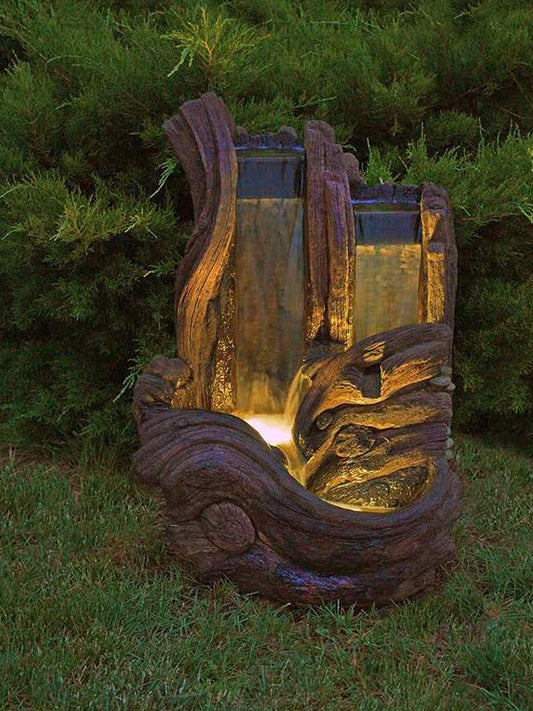 Outdoor water feature with two waterfalls and a log design