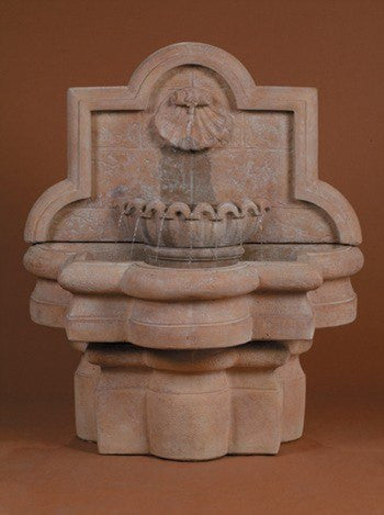 Small outdoor wall fountain with shell and quatrefoil design
